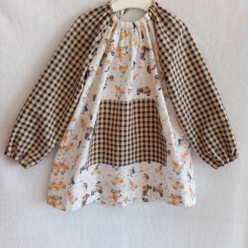 Bata infantil Animalitos sobre ruedas